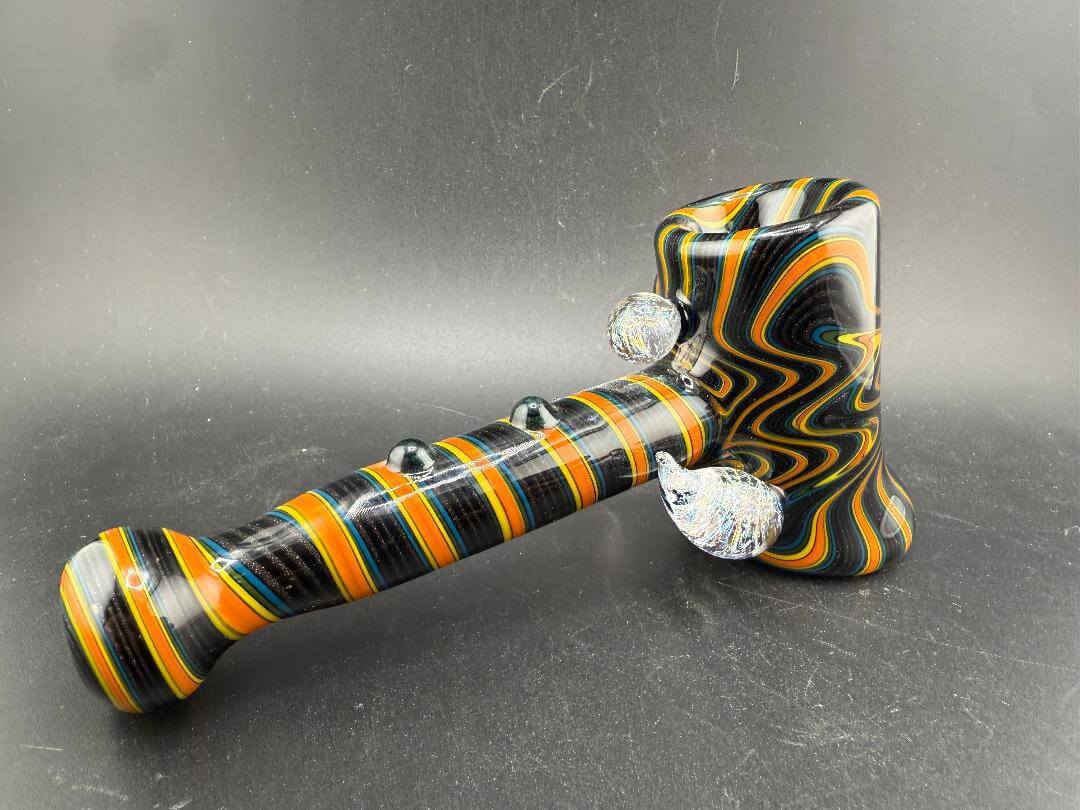 Filla John Glass Hammer Pipe - Orange & Black Line Worked w/ Dichro Attachments showcasing vibrant design and unique craftsmanship.