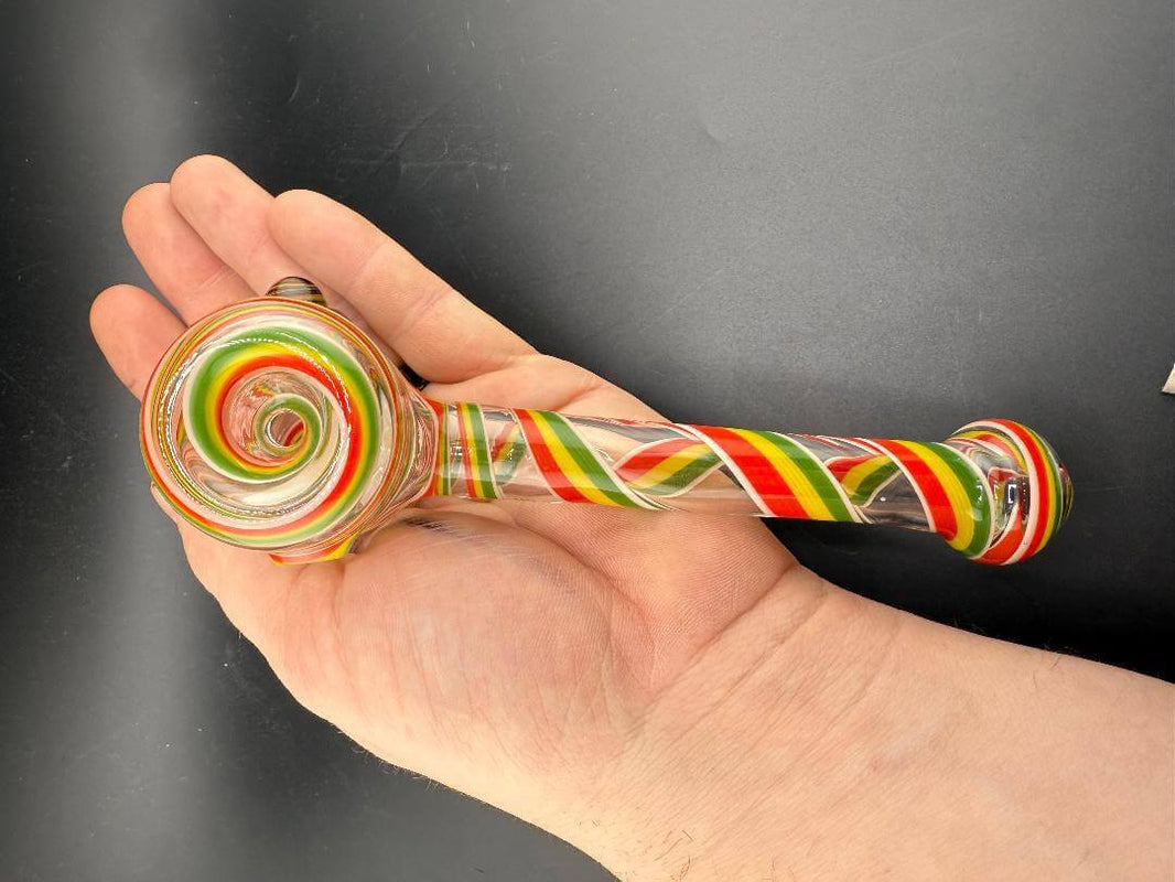 Filla John Glass Hammer Pipe - Rasta Line Work held in hand showcasing vibrant colors and spiral design.