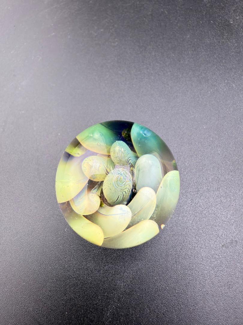 Filla John Glass Marble - Fumed Implosion Approx. 1.25" featuring a mesmerizing layered design.