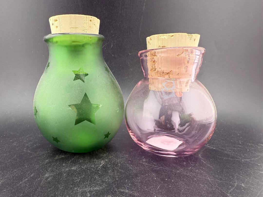 Filla John Glass Round Nug Cork Jars - Stars displayed in green and pink with sandblasted star designs and cork lids.