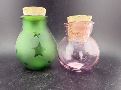 Filla John Glass Round Nug Cork Jars - Stars displayed in green and pink with sandblasted star designs and cork lids.