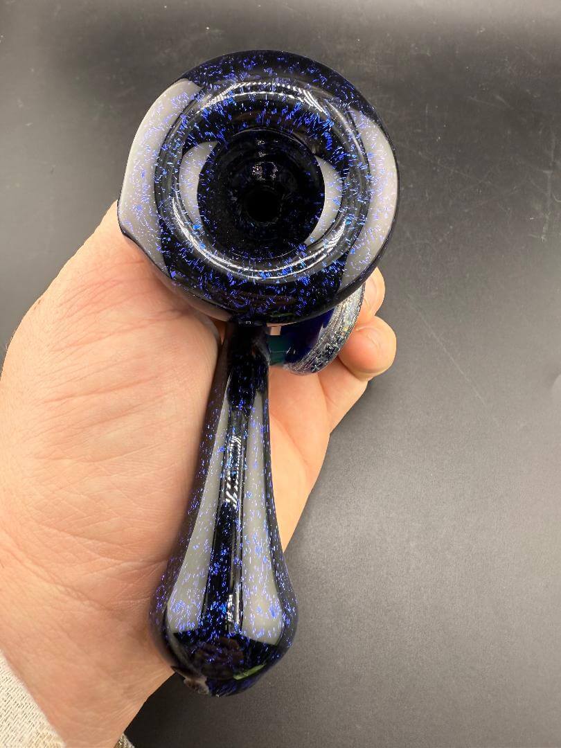 Filla John Glass Sherlock Pipe - Blue Dichro w/ Dichro Pendant Attachment held in hand showcasing its striking design.