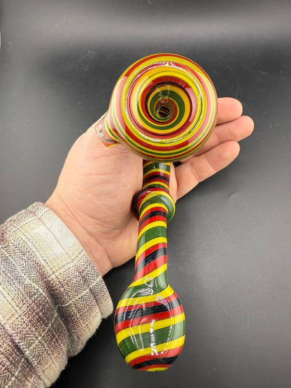 Filla John Glass Sherlock Pipe - Rasta Line Worked w/ Millie Attachments shown in hand, showcasing the vibrant colors and design.