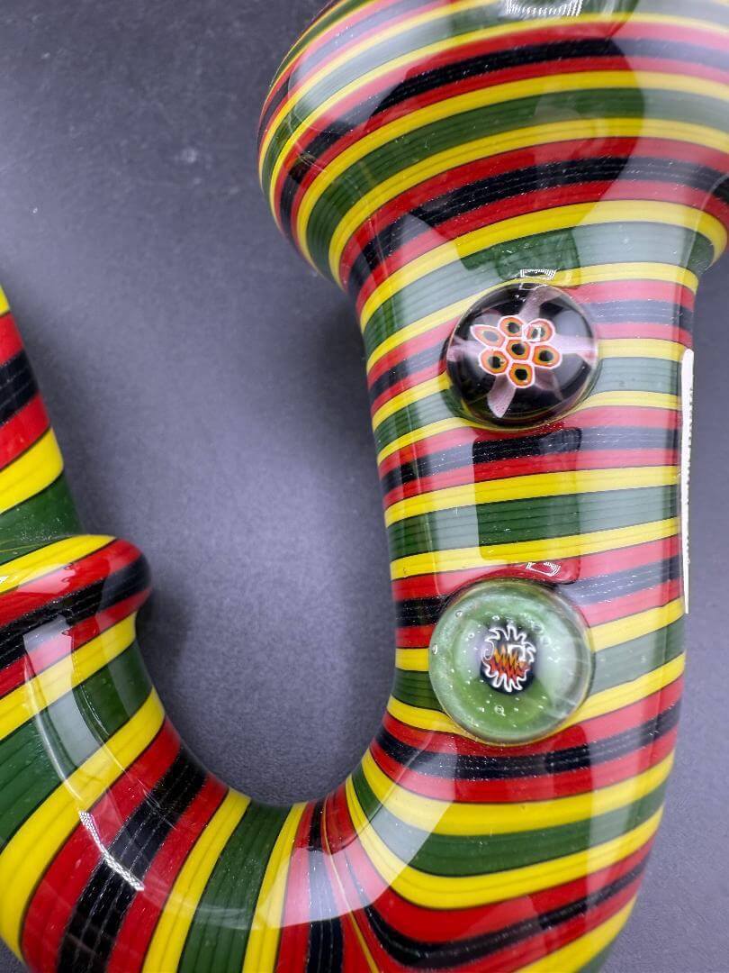 Filla John Glass Sherlock Pipe - Rasta Line Worked w/ Millie Attachments showcasing vibrant colors and intricate designs.