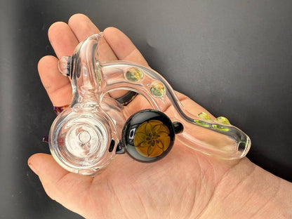 Filla John Glass Sidecar Pipe   Clear w/ Color Accents & Pendant Attachments in hand, showcasing its unique design and details.