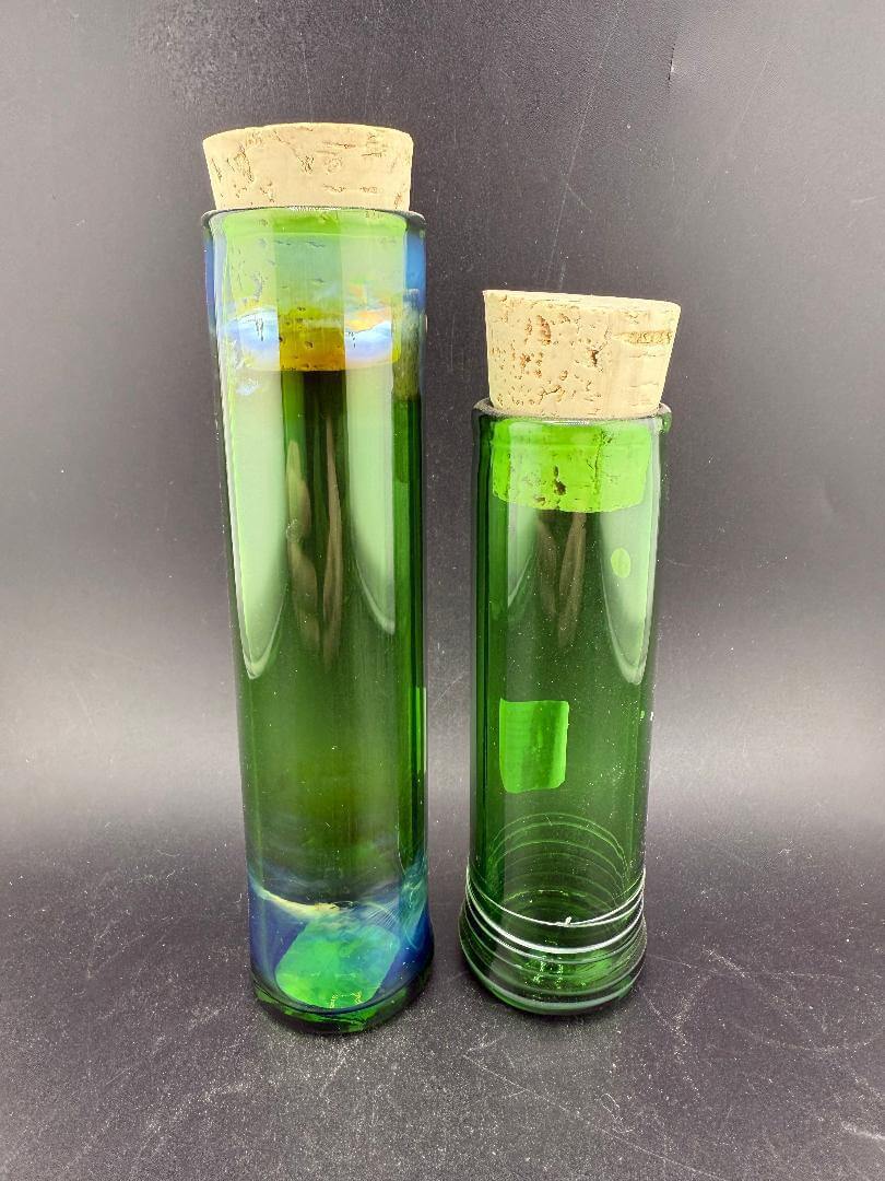 Filla John Glass Tall Nug Cork Jar - Green displayed alongside another tall green jar with cork lids.
