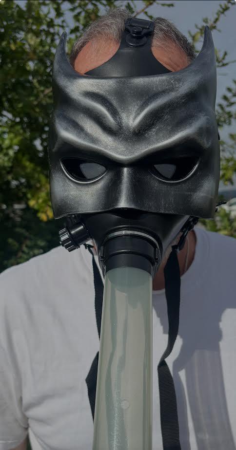 Gas Mask with Water Pipe worn by a person outdoors, showcasing a unique party statement for Halloween.