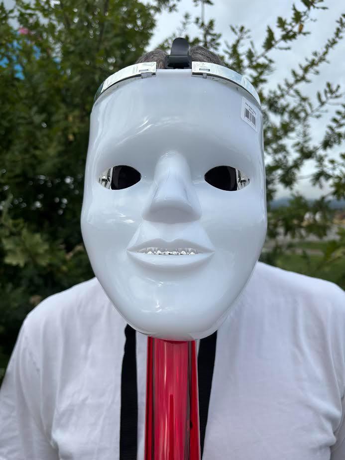 Gas Mask with Water Pipe displayed outdoors on a person wearing a white shirt.