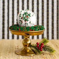 Whipped Up Wonderful Gingerbread Brulee Bath Bomb on a decorative stand with festive sprinkles.