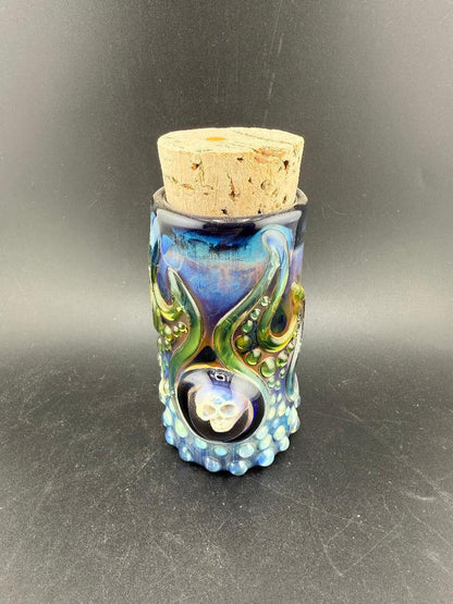 Glass Distractions Fumed Skull Cork Jar with intricate blue design and cork lid, showcasing artistry and unique color transitions.
