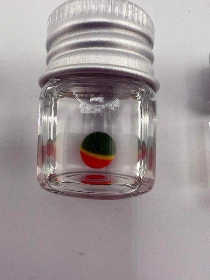 Clear glass container with colorful Pokeball design at the bottom, ideal for storing dab accessories.