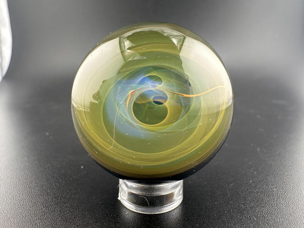 Guido Glass Marble - Chaos Backed Fumed Swirl showcasing a captivating swirl of colors and depth.