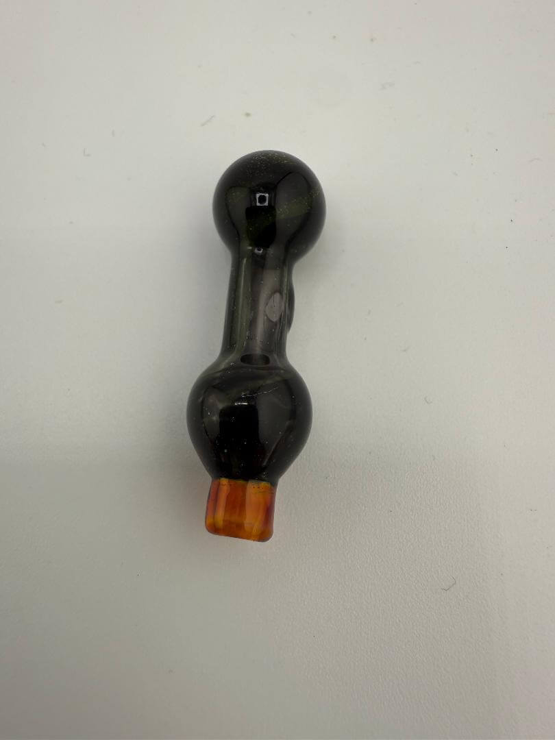 Close-up of a handcrafted black glass puffco ball cap with an orange accent, designed for optimal airflow.
