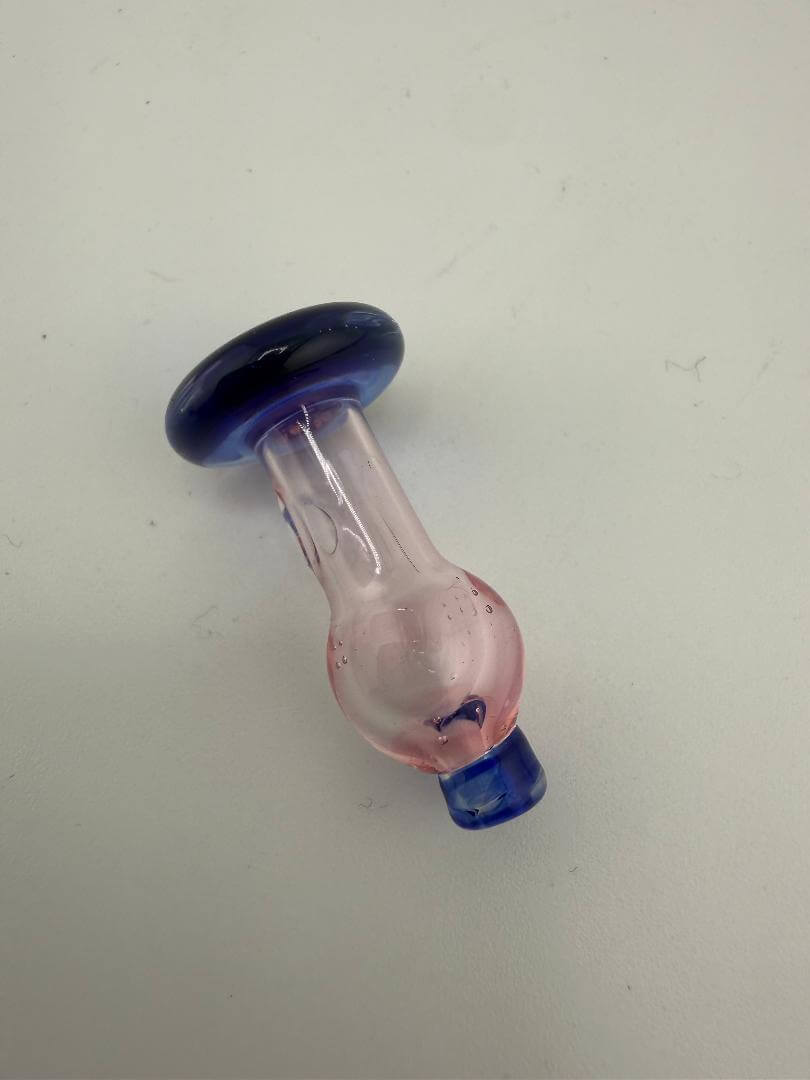 Handcrafted pink and blue glass ball cap designed for Puffco Peak Pro, optimizing airflow for flavorful dabs.