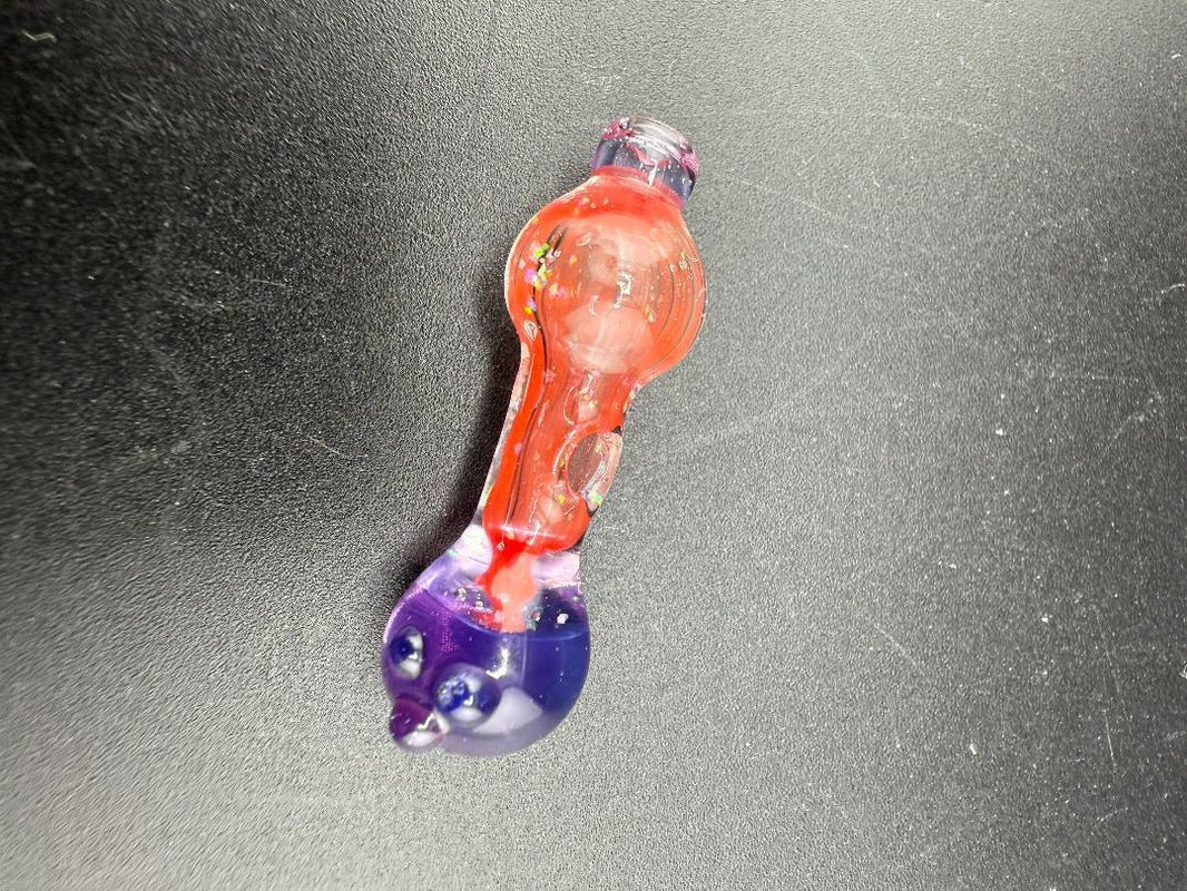 Colorful hand-blown glass pipe with red and purple hues, perfect for enjoyable smoking sessions.