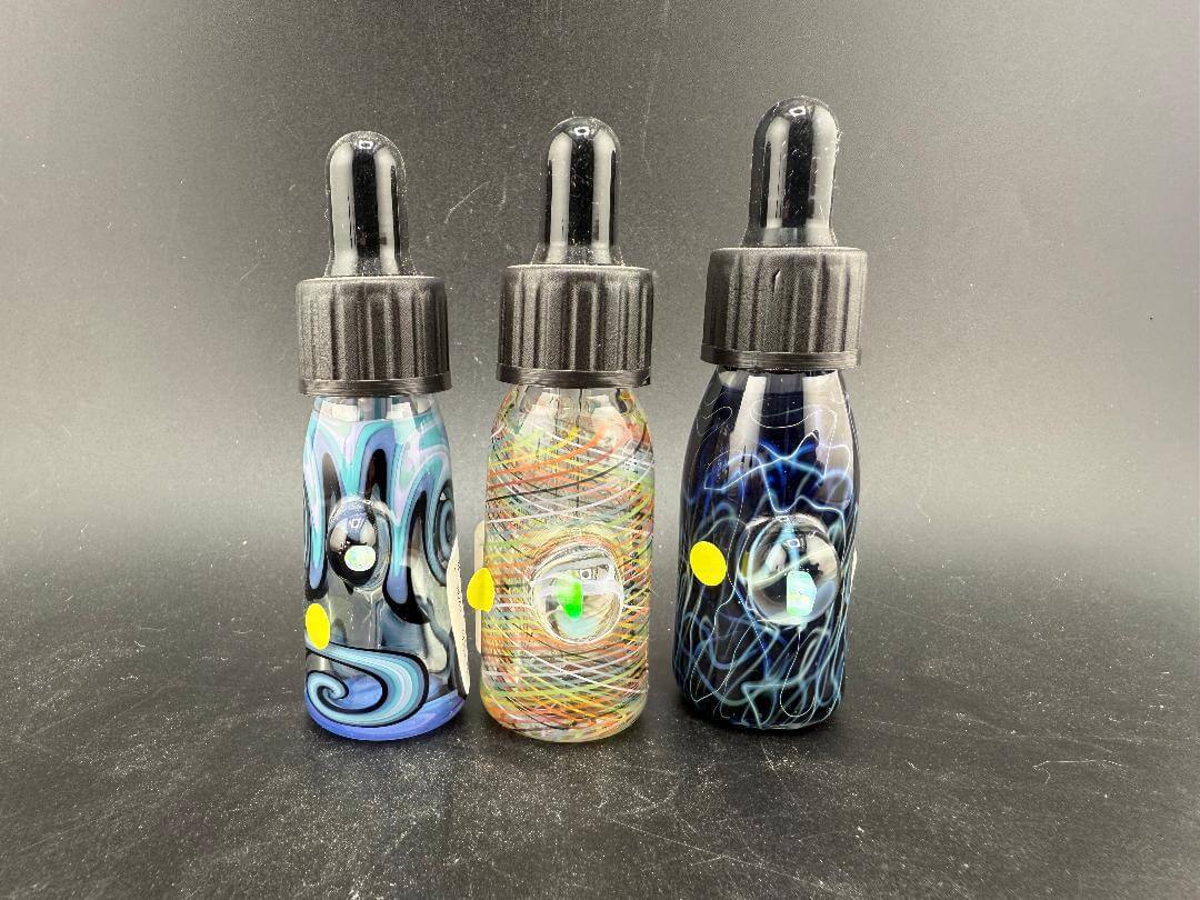 Highgrade Glass Dropper Bottle / Vial - Worked showcasing three unique handblown vials with intricate designs.