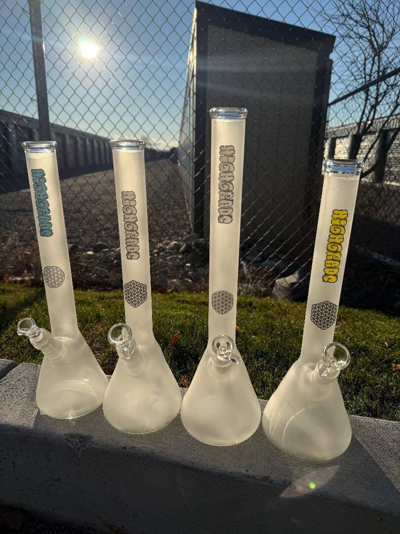 Highgrade Glass Flower Beaker - Sandblasted w/ Sacred Geometry Bake on 14mm 45° displayed in a sunny outdoor setting.