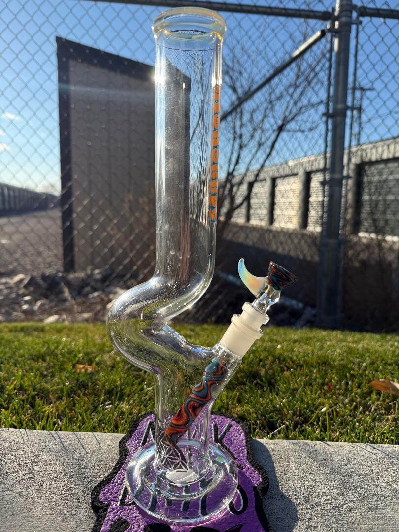 Highgrade Glass Flower Straight Tube – Fire & Ice Wig Wag Color Accent Pistol Loop 14mm 45° displayed outdoors.