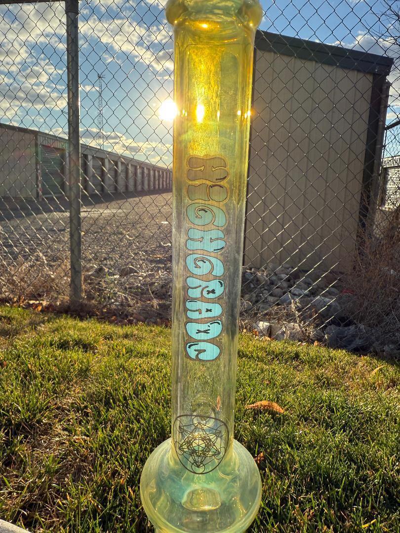 Highgrade Glass Flower Straight Tube - Fumed Bowl & Downstem w/ Sacred Geometry Bake Ons 14mm 45° on grass during sunset.