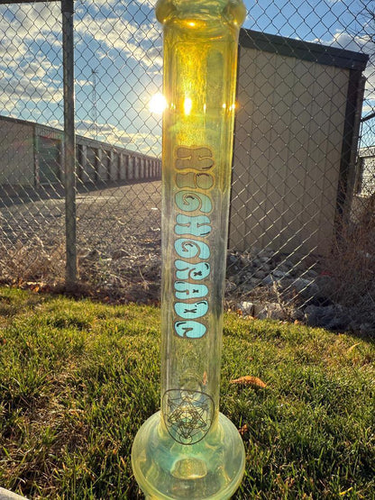 Highgrade Glass Flower Straight Tube - Fumed Bowl & Downstem w/ Sacred Geometry Bake Ons 14mm 45° on grass during sunset.