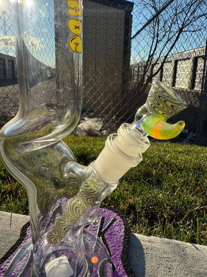 Highgrade Glass Flower Straight Tube – Green & White Wig Wag Color Accent Pistol Loop 14mm 45° displayed outdoors.