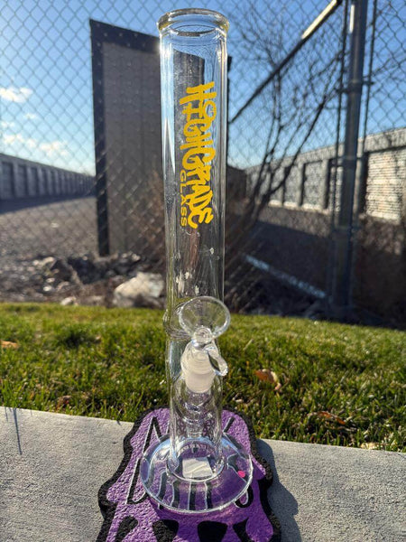 Highgrade Glass Flower Straight Tube - Pistol Loop Straight w/ Sacred Geometry Bake On 14mm 45° displayed outdoors with a distinctive design.