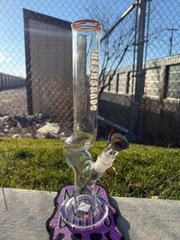 Highgrade Glass Flower Straight Tube - Rainbow & Amber Wig Wag Color Color Accent Pistol Loop 14mm 45° on a grassy surface.