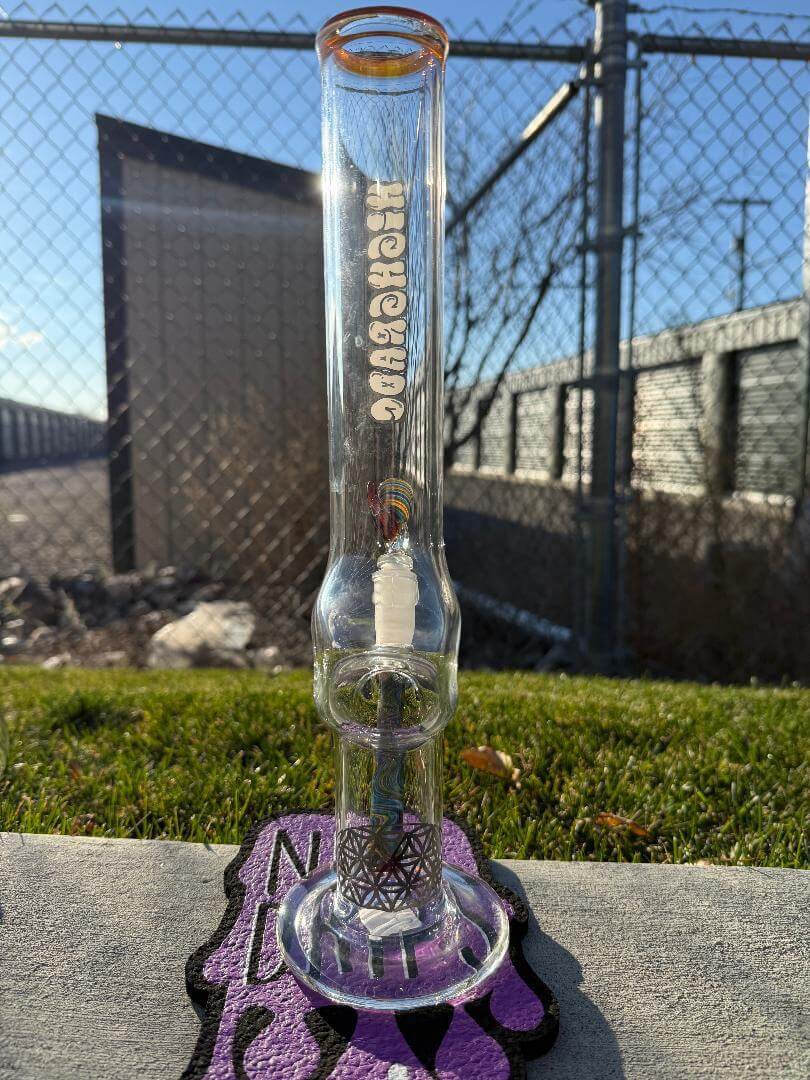 Highgrade Glass Flower Straight Tube - Rainbow & Amber Wig Wag Color Color Accent Pistol Loop 14mm 45° showcased outdoors.