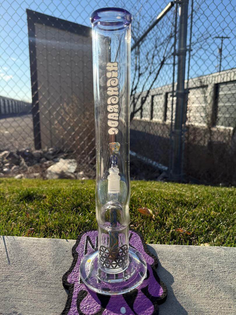 Highgrade Glass Flower Straight Tube - Rainbow & Blue Wig Wag Color Color Accent Pistol Loop 14mm 45° displayed outdoors.