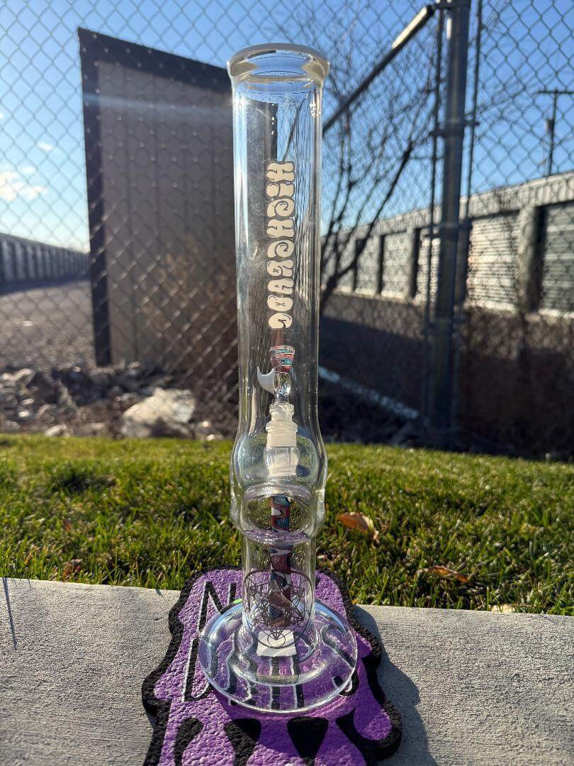 Highgrade Glass Flower Straight Tube – Red, White & Blue Wig Wag Color Accent Pistol Loop 14mm 45° displayed outdoors.