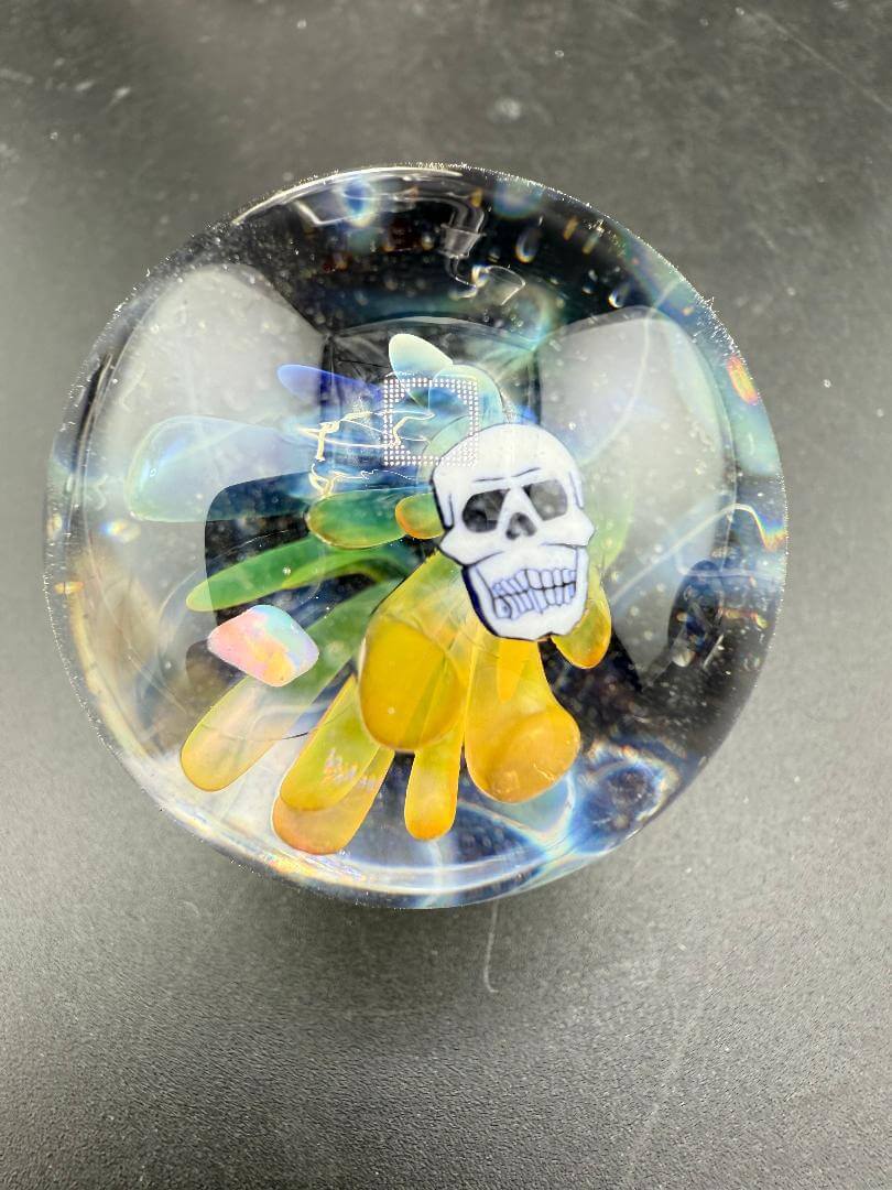 Highgrade Glass Marble - 38mm Skull Millie Implosion showcasing vibrant design and detailed craftsmanship.