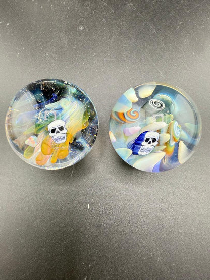 Highgrade Glass Marble - 38mm Skull Millie Implosion displayed in two colorful designs with vibrant details.