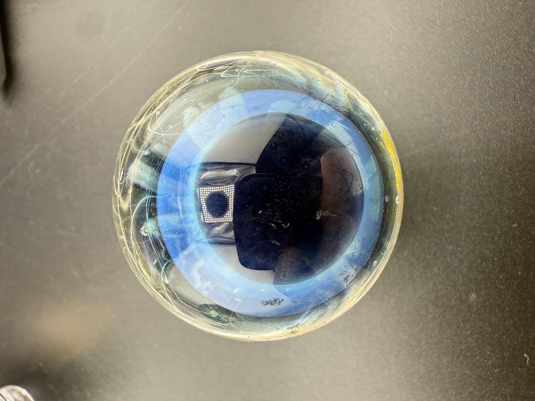 Highgrade Glass Marble - 40mm Millie Implosion w/ Opal Encasement showcasing multidimensional design.