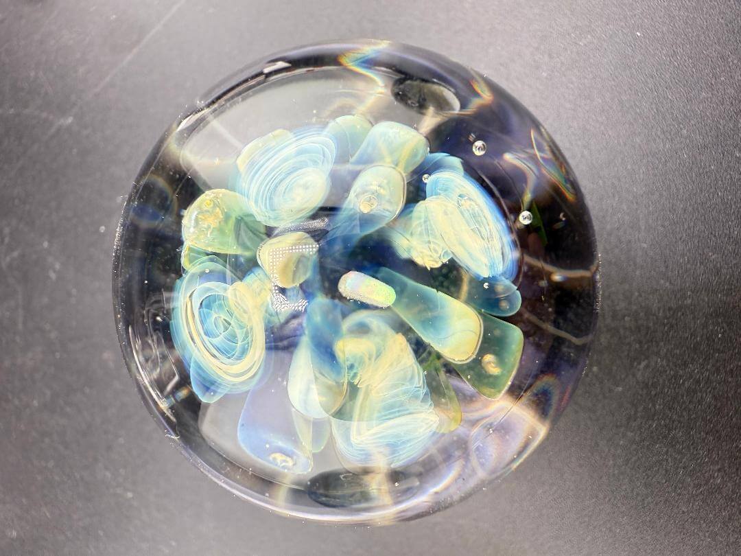 Highgrade Glass Marble - 40mm Millie Implosion w/ Opal Incasment featuring a vibrant millie implosion design and opal encasement.