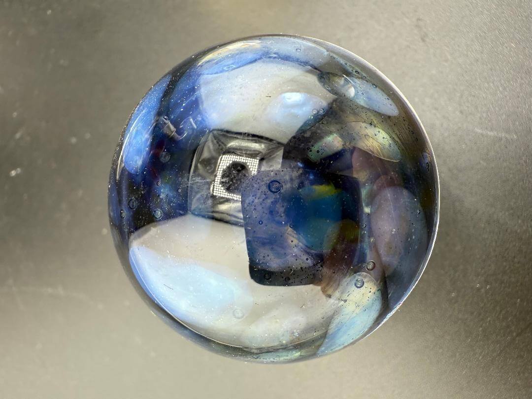 Highgrade Glass Marble - 40mm Millie Implosion w/ Opal Encasment showcasing vibrant colors and intricate design.