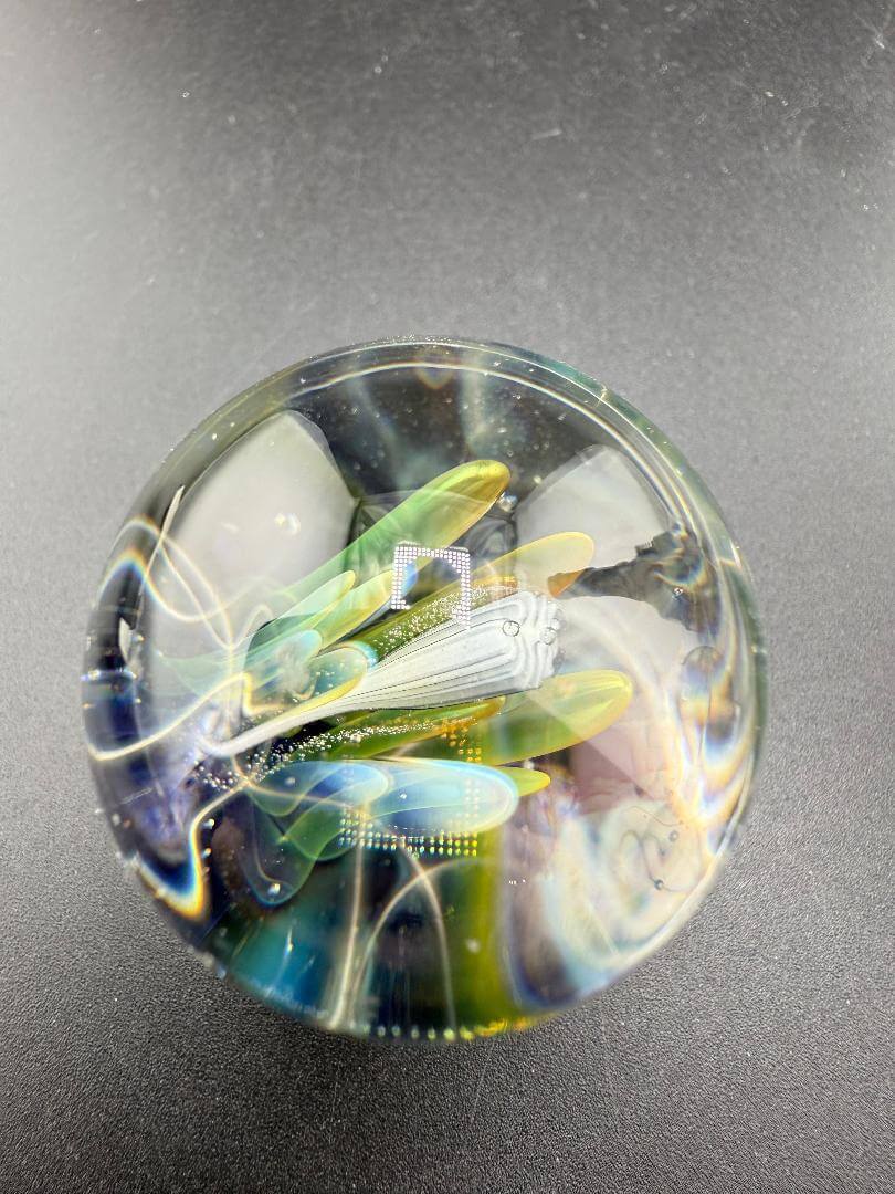 Highgrade Glass Marble - Fumed Implosion Apporx. 1.4" showcasing a vibrant, layered design with implosion effect.