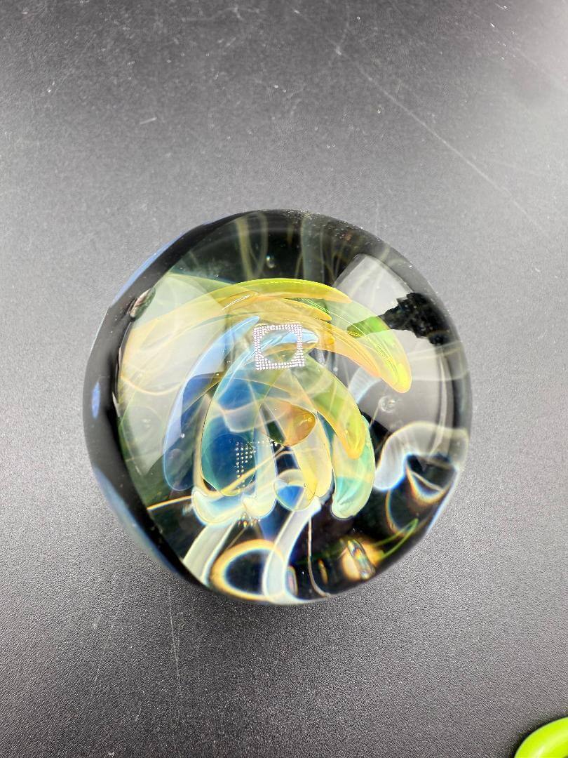 Highgrade Glass Marble - Fumed Implosion Approx. 1.4" showcasing colorful layered design and implosion effect.