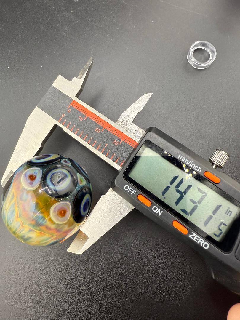 Highgrade Glass Marble - Fumed Implosion Dot Stack Marble 1.4" measurement shown with calipers.