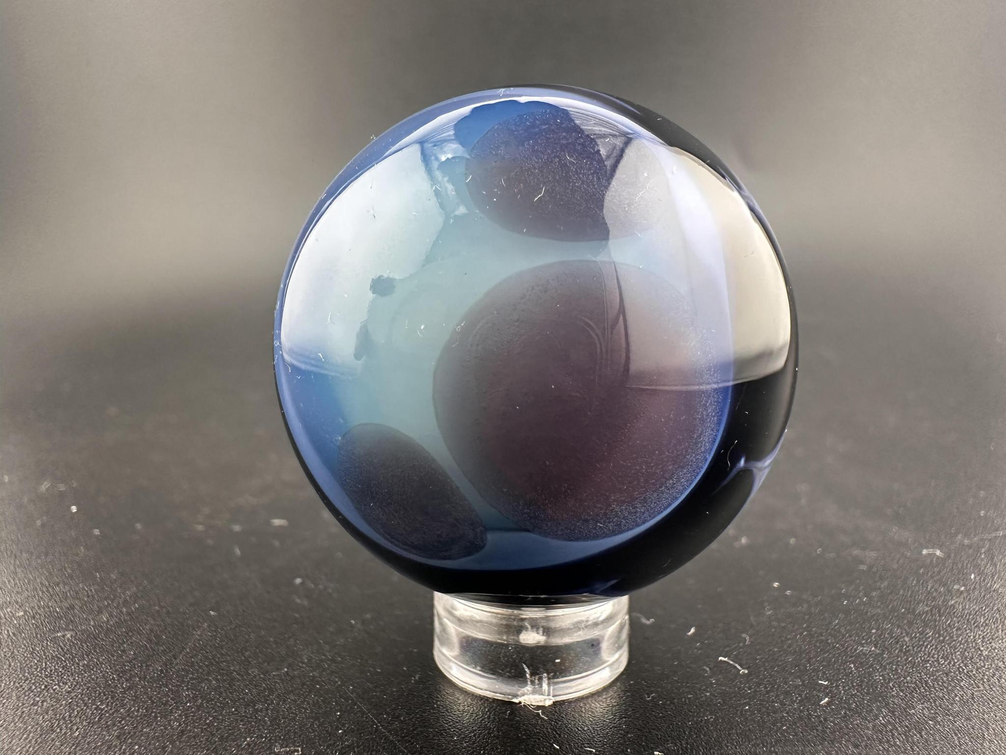 Highgrade Mike Glass Marble -Rising Ocean Swirl displaying a dynamic oceanic swirl pattern in shades of blue and teal.