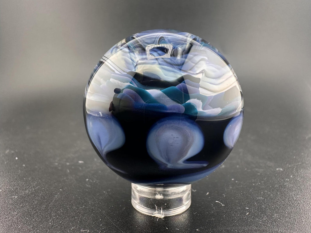 Highgrade Mike Glass Marble -Rising Ocean Swirl displaying dynamic oceanic blues and teals in a handcrafted design.