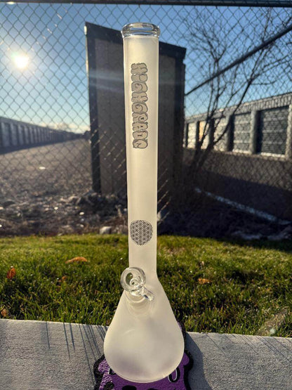 Highgrade Glass Flower Beaker - Sandblasted w/ Sacred Geometry Bake on 14mm 45° on a sunny day with grass background.
