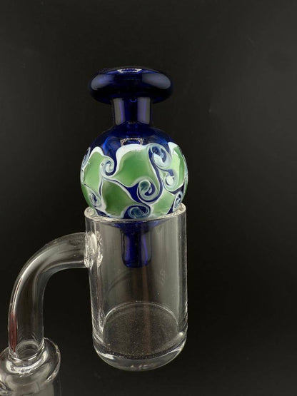 Import Bubble Cap 25mm - Dot Stack on a quartz banger, featuring a colorful swirl design.