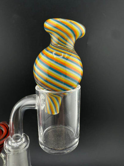Import Bubble Cap 25mm - Line Worked in vibrant rainbow colors atop a quartz banger for optimal airflow.