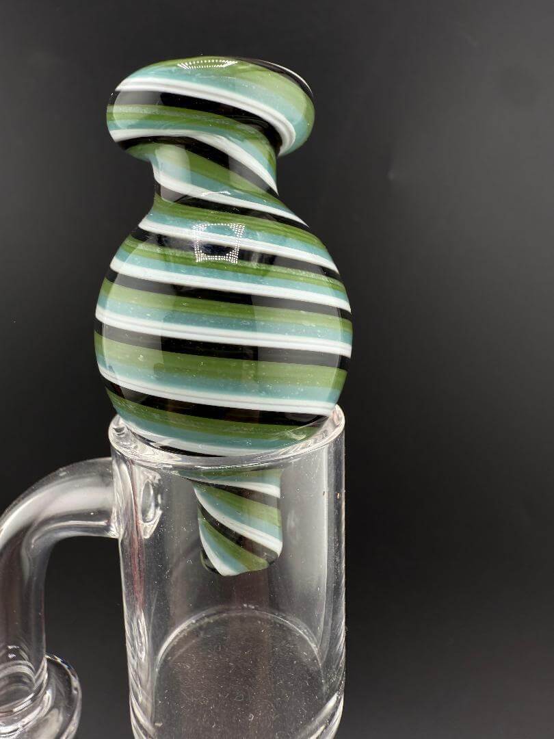 Import Bubble Cap 25mm - Line Worked in green and black stripes on a quartz banger.