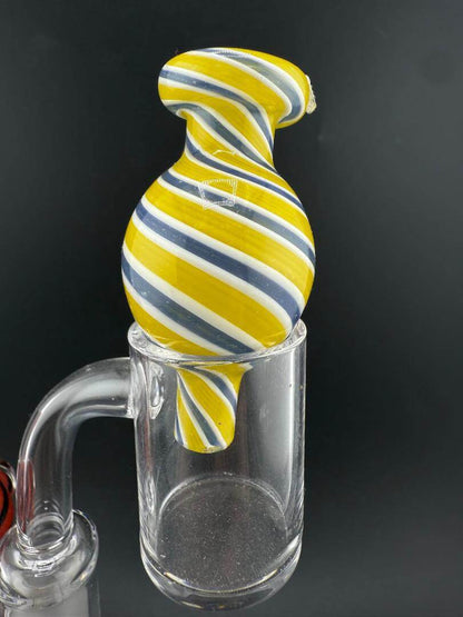 Import Bubble Cap 25mm - Line Worked in yellow and blue stripes on a quartz banger.