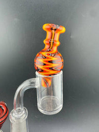 Import Bubble Cap 25mm - Wig Wag in vibrant orange and black pattern on flat-top quartz banger.
