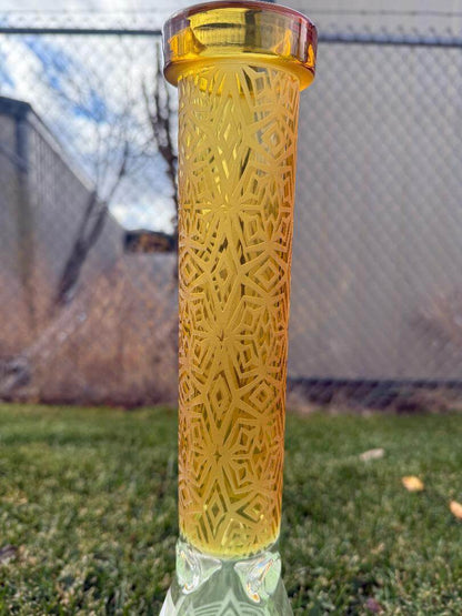 Import Frosted Stars Beaker 14mm 45° displayed outdoors showcasing its frosted design and golden liquid.