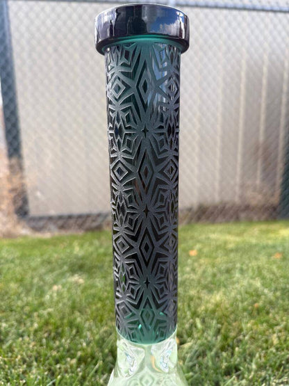 Import Frosted Stars Beaker 14mm 45° with intricate patterned design and green accents against grass background.