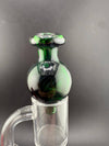 Import Glass Bubble Cap - North Star in green color on a quartz banger.