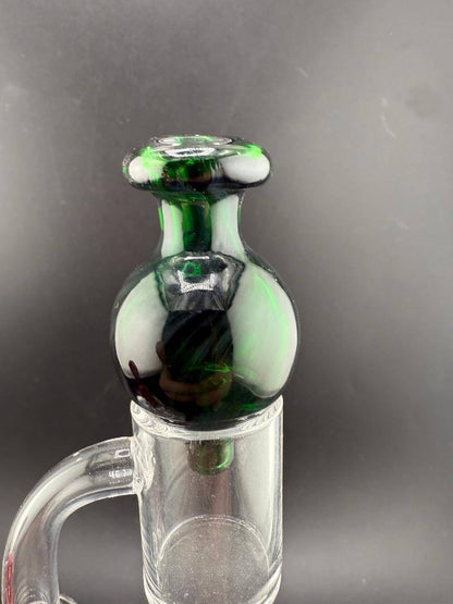Import Glass Bubble Cap - North Star in green color on a quartz banger.